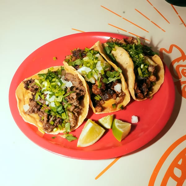 Three El Santo Gallo Taqueria tacos with meat, cilantro, and onions, served with lime wedges.
